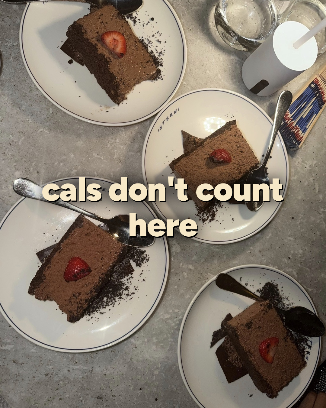 Four slices of chocolate cake on a marble table