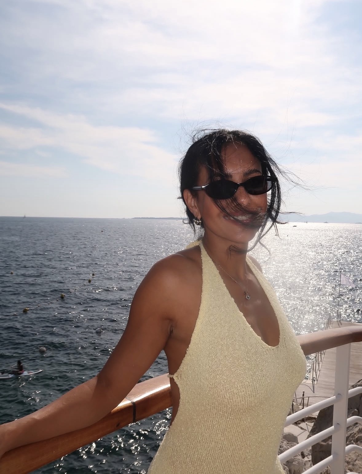 Nakita in a knit halter top by the sea in Saint-Tropez, France